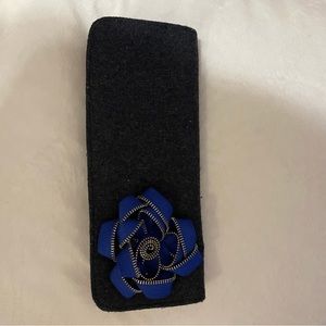 Grey flannel clutch with blue zipper flower detail.